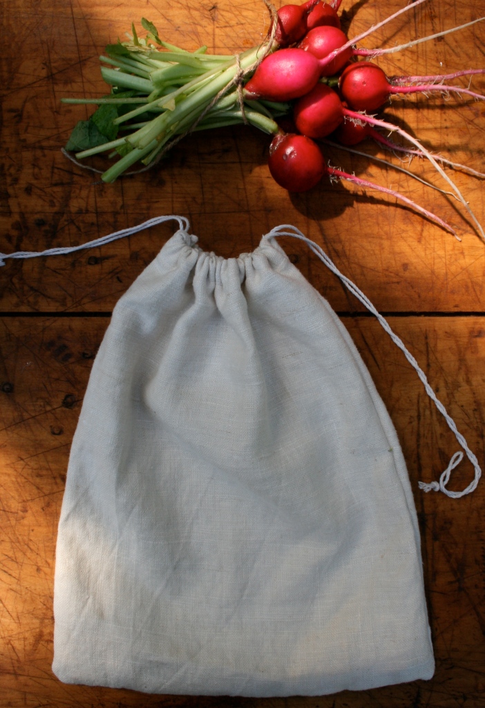 This small linen towel folded in half and stitched on both sides, makes the perfect bag.